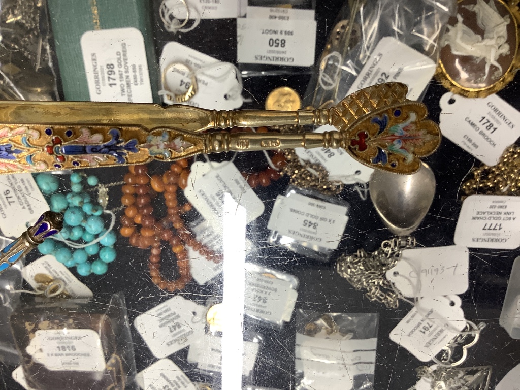 A small collection of Russian and Russian style white metal spoons etc, some with enamel or niello decoration.